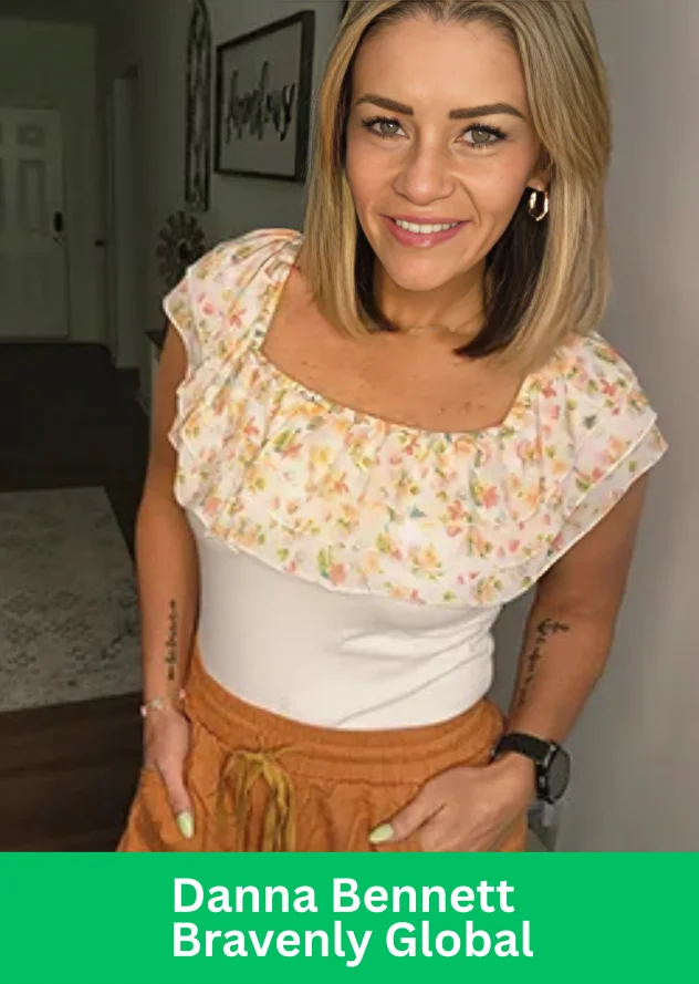 Danna Bennett of Bravenly Global, recently promoted to Executive Vice President, standing confidently in a bright floral top and smiling.