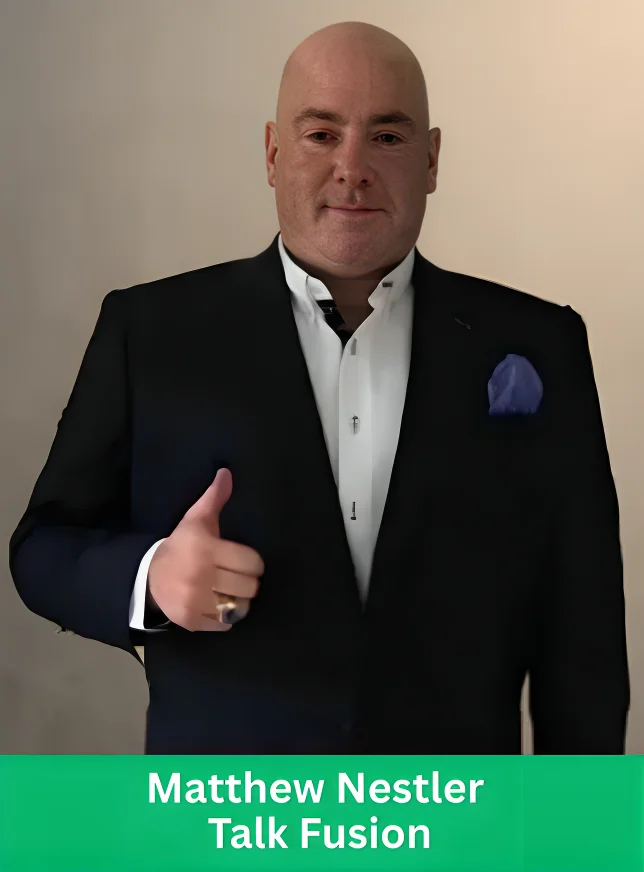 Matthew Nestler wearing a suit and giving a thumbs up, representing Talk Fusion