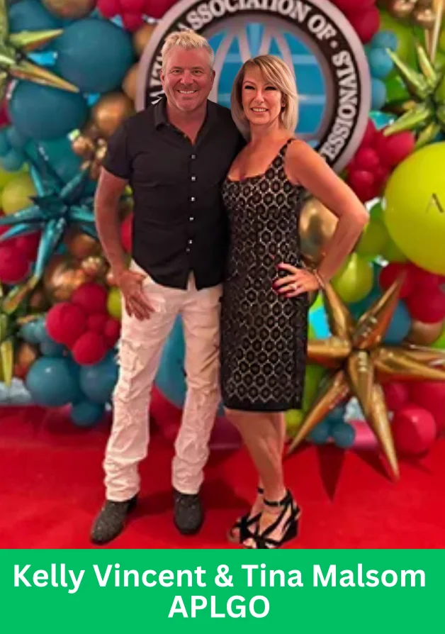 Kelly Vincent and Tina Malsom posing at an APLGO event with colorful backdrop