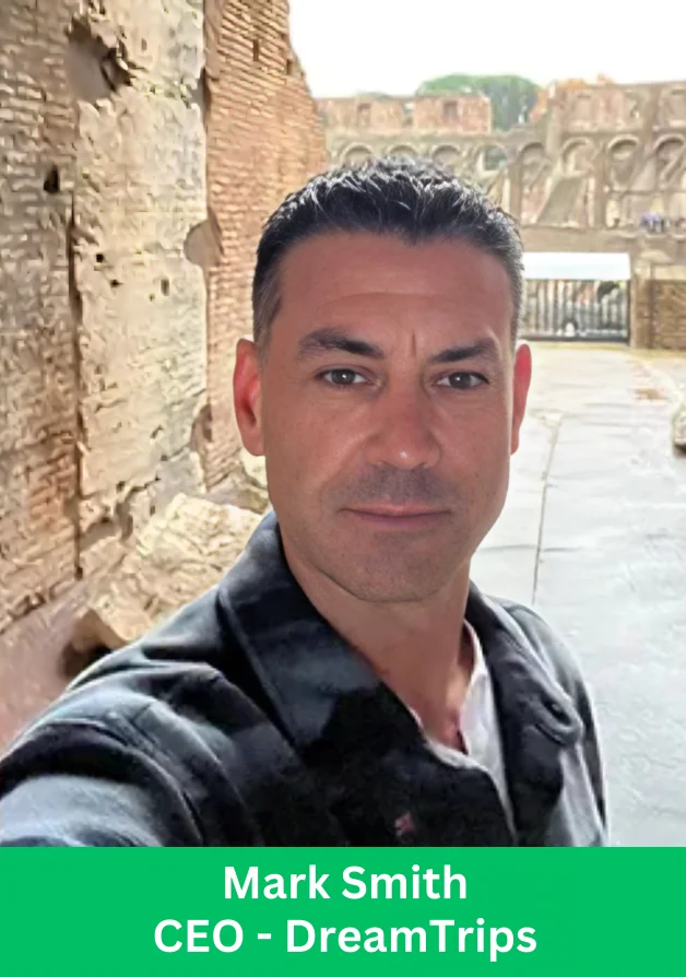 A DreamTrips leadership profile photo of a man standing in front of historic stone architecture.