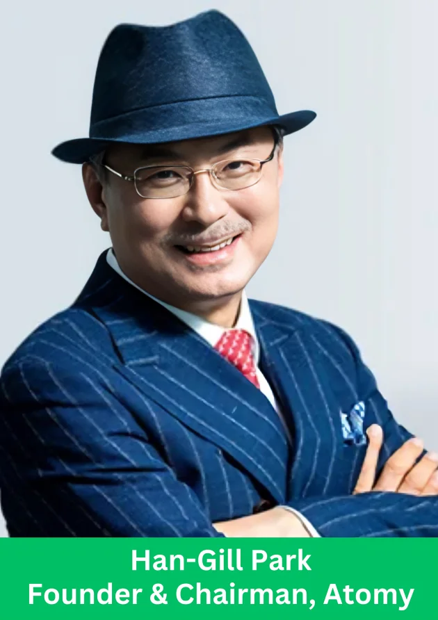 Portrait of Han Gill Park, Founder and Chairman of Atomy, wearing a blue suit and hat