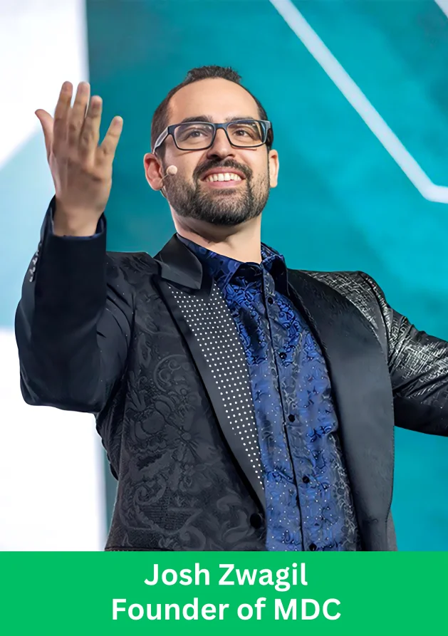 Josh Zwagil MDC founder speaking on stage during a company event