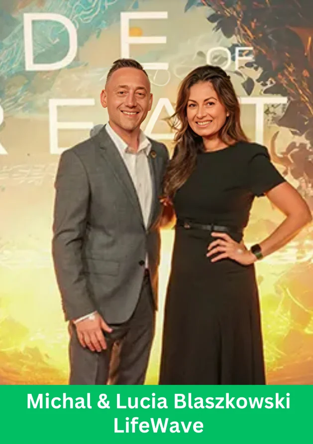 A well-dressed couple posing together at a LifeWave event with a warm background
