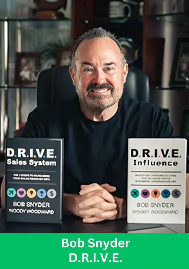 Bob Snyder sitting with his D.R.I.V.E. books showcasing leadership and sales influence