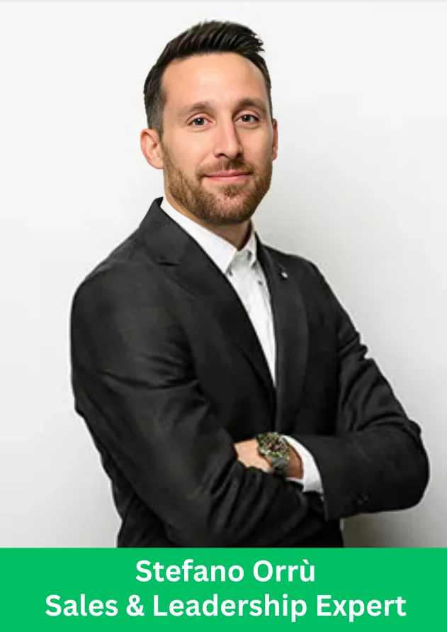 Stefano Orru leadership expert posing in a formal suit with arms crossed