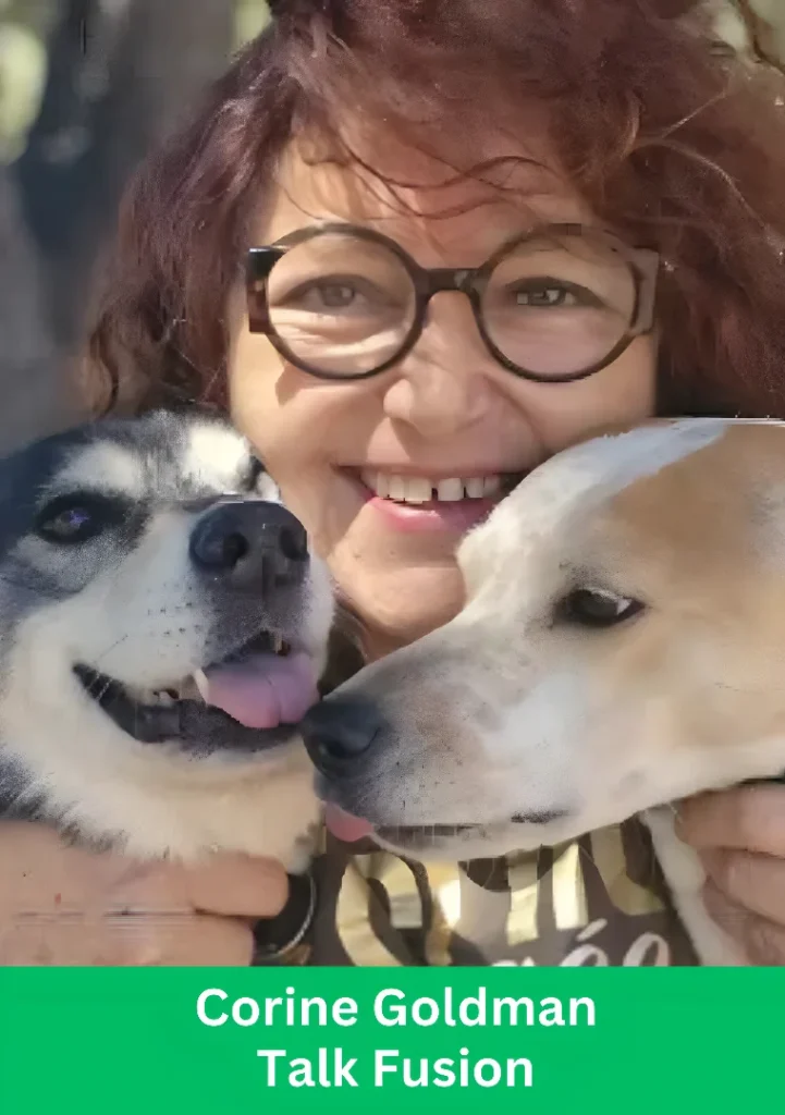 Corine Goldman from Talk Fusion smiling while holding two dogs