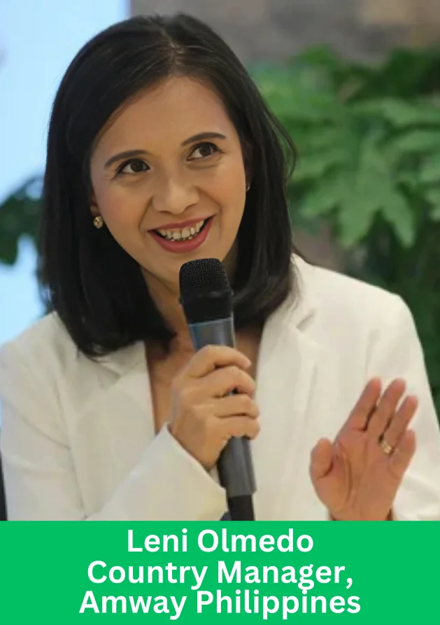 Leni Olmedo, Country Manager of Amway Philippines, speaking confidently while holding a microphone