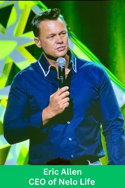 Eric Allen, CEO of Nelo Life, speaking on stage during a company event