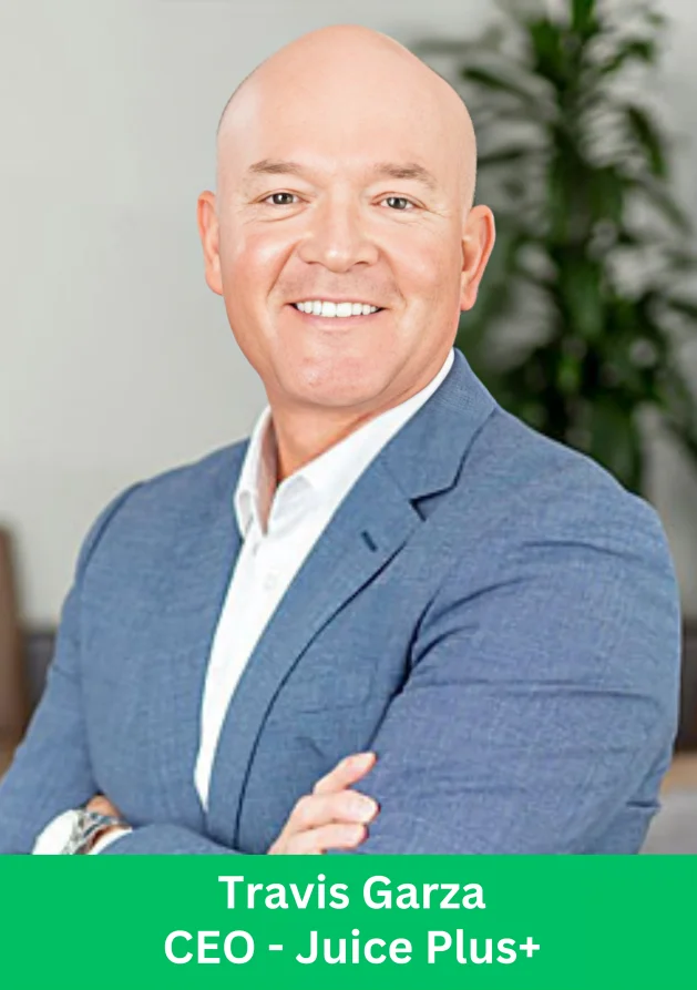 Travis Garza, CEO of Juice Plus+, posing confidently with arms crossed.