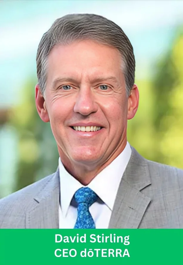 David Stirling CEO dōTERRA smiling in a professional business portrait wearing a gray suit and blue tie