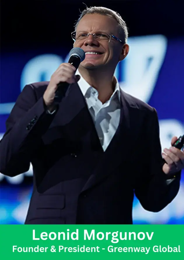 Leonid Morgunov Founder and President of Greenway Global speaking on stage holding microphone