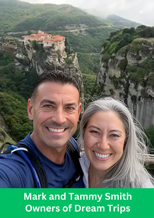 Mark and Tammy Smith, owners of Dream Trips, posing in front of a scenic mountain and cliffside destination