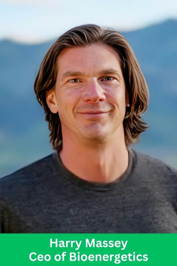 Portrait of Harry Massey, CEO of Bioenergetics, smiling outdoors with a blurred mountain background.