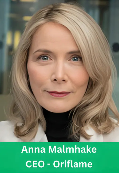 Professional corporate headshot of Anna Malmhake, CEO of Oriflame, with blonde hair, wearing a white blazer and a black turtleneck.