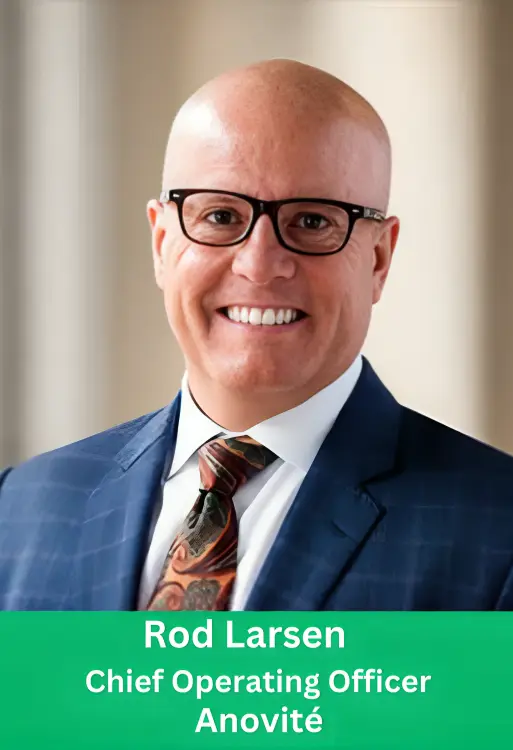 Professional headshot of Rod Larsen, Chief Operating Officer of Anovité, smiling in a blue business suit and glasses.