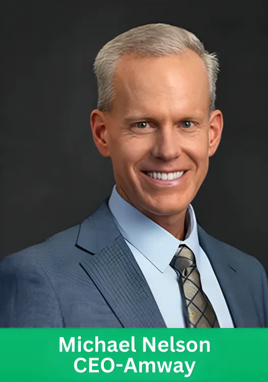 Professional portrait of Michael Nelson, CEO of Amway, smiling in a business suit.