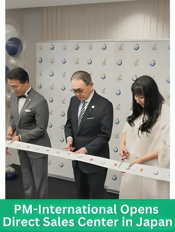 PM International team performing ribbon cutting ceremony at the grand opening of their new Direct Sales Center in Japan. Three executives, including a woman in white, officially inaugurate the facility.