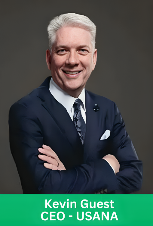 Professional corporate portrait of Kevin Guest, CEO of USANA, wearing a dark suit with a patterned tie and pocket square, smiling with arms crossed. A green banner at the bottom displays his name and title.