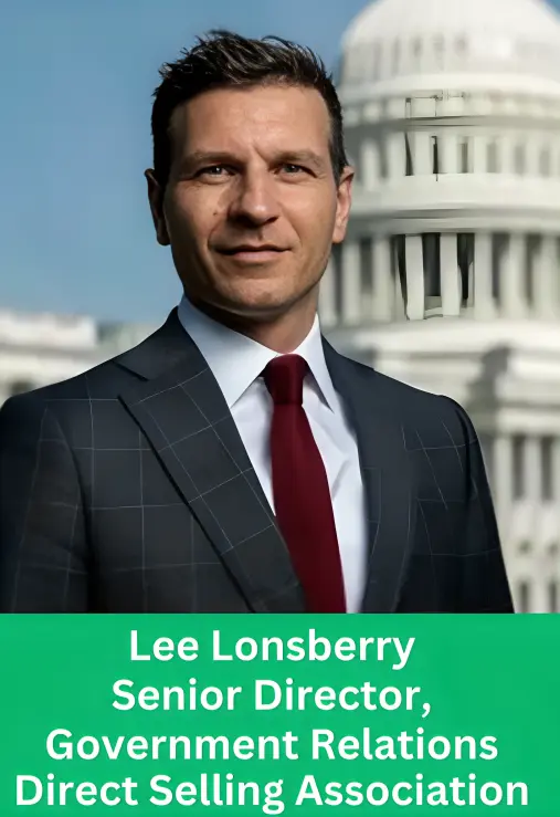 Professional portrait of Lee Lonsberry, Senior Director of Government Relations at the Direct Selling Association, wearing a dark suit and maroon tie, with a blurred US Capitol building in the background