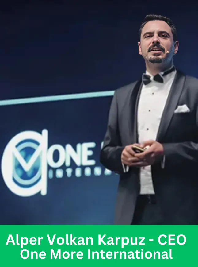 Alper Volkan Karpuz speaking on stage at a One More International event.
